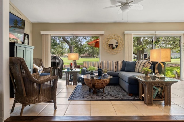 tiled living area featuring healthy amount of natural light and a ceiling fan