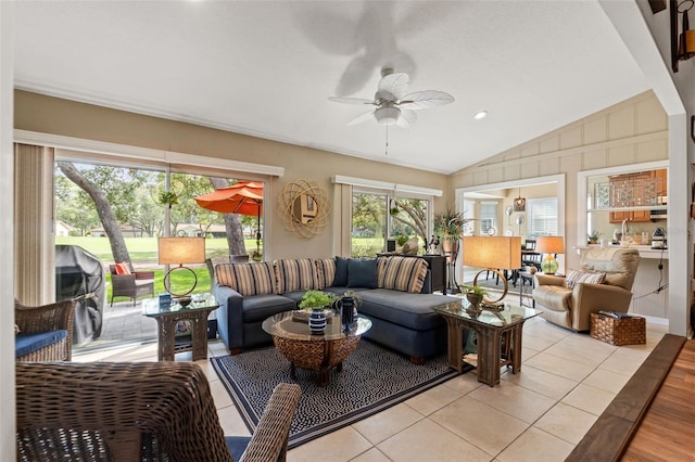 living area featuring vaulted ceiling, a ceiling fan, light tile patterned flooring, and recessed lighting