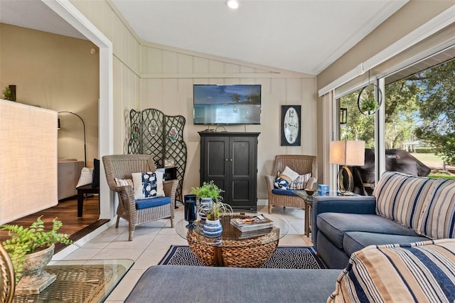 living room with vaulted ceiling and light tile patterned floors