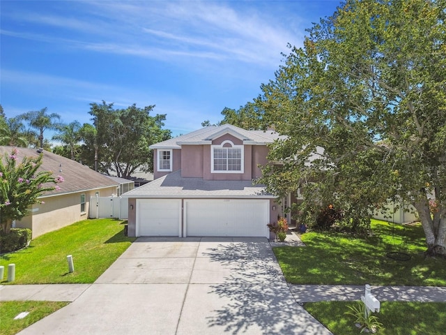 1120 Bluffs Cir, Dunedin, FL 34698 - view of front of house with an attached garage, stucco siding, concrete driveway, and roof with shingles
