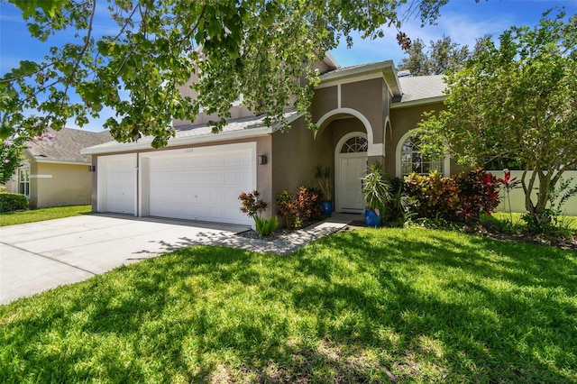 1120 Bluffs Cir, Dunedin, FL 34698 - view of front facade featuring driveway, a front lawn, stucco siding, and an attached garage