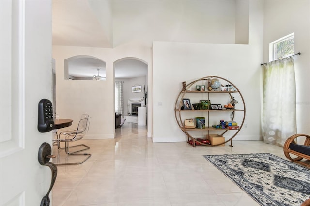 1120 Bluffs Cir, Dunedin, FL 34698 - tiled foyer entrance with arched walkways and a towering ceiling