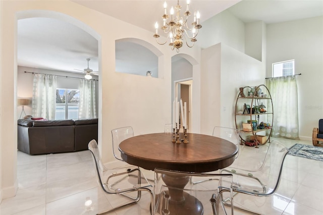 1120 Bluffs Cir, Dunedin, FL 34698 - dining space featuring arched walkways, light tile patterned floors, ceiling fan, and a chandelier