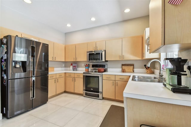 1120 Bluffs Cir, Dunedin, FL 34698 - kitchen featuring stainless steel appliances, light brown cabinets, light tile patterned floors, light countertops, and recessed lighting