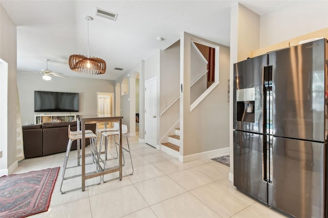 1120 Bluffs Cir, Dunedin, FL 34698 - dining room with a ceiling fan, arched walkways, stairway, and light tile patterned flooring