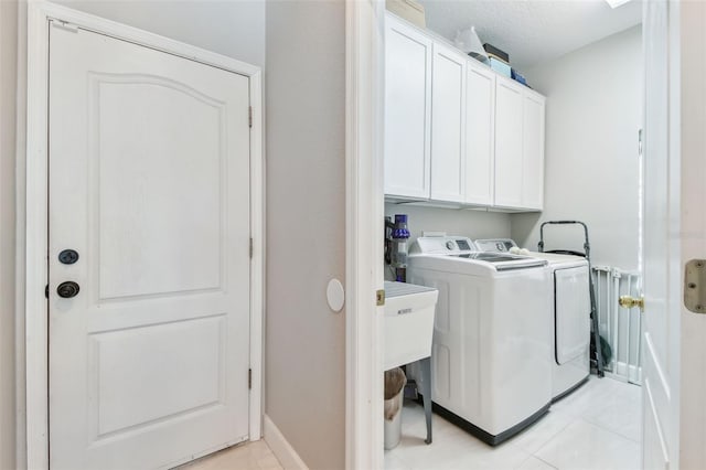 1120 Bluffs Cir, Dunedin, FL 34698 - laundry room with washing machine and dryer, cabinet space, and light tile patterned floors