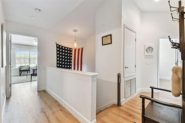 1120 Bluffs Cir, Dunedin, FL 34698 - hallway featuring an upstairs landing, light wood-style floors, and a chandelier