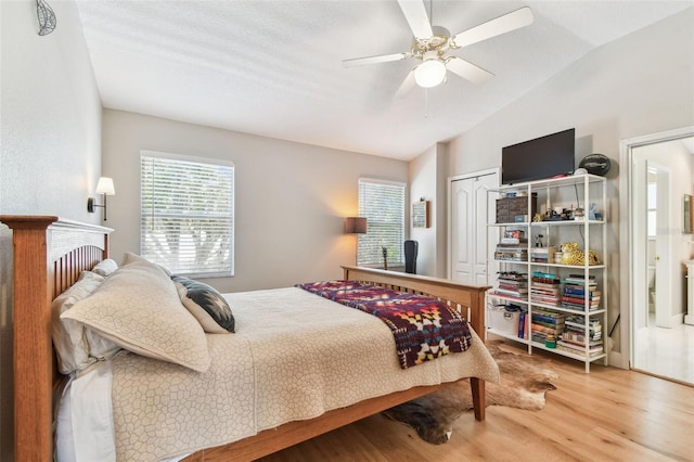 1120 Bluffs Cir, Dunedin, FL 34698 - bedroom with wood finished floors, lofted ceiling, a closet, and ceiling fan