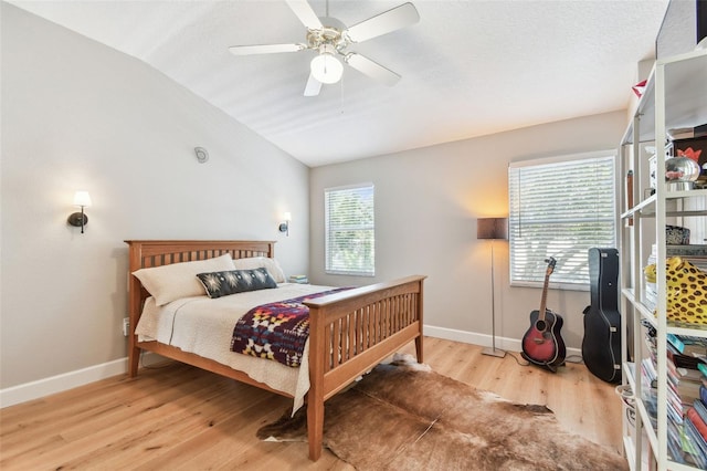 1120 Bluffs Cir, Dunedin, FL 34698 - bedroom with lofted ceiling, wood finished floors, and ceiling fan