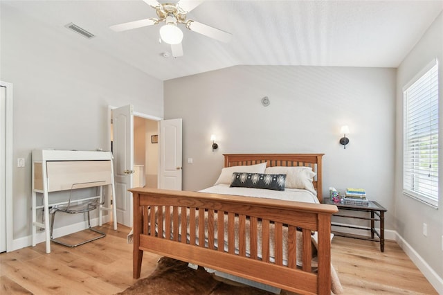 1120 Bluffs Cir, Dunedin, FL 34698 - bedroom with light wood-type flooring, vaulted ceiling, and a ceiling fan