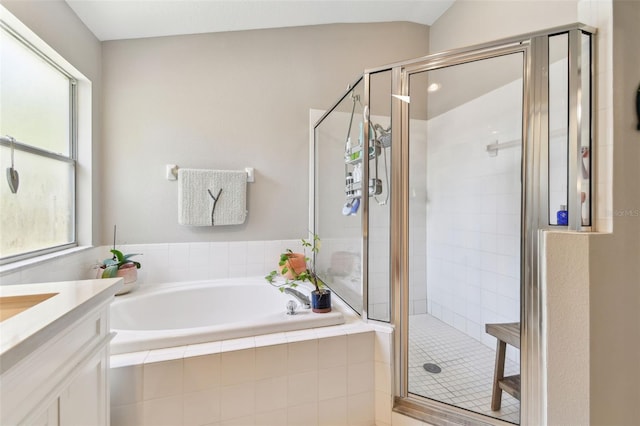 1120 Bluffs Cir, Dunedin, FL 34698 - bathroom with a garden tub, vanity, and a stall shower