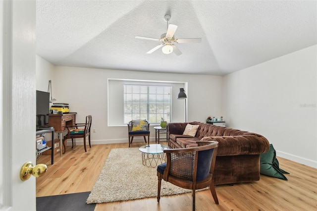 1120 Bluffs Cir, Dunedin, FL 34698 - living area featuring wood finished floors, a ceiling fan, and a textured ceiling