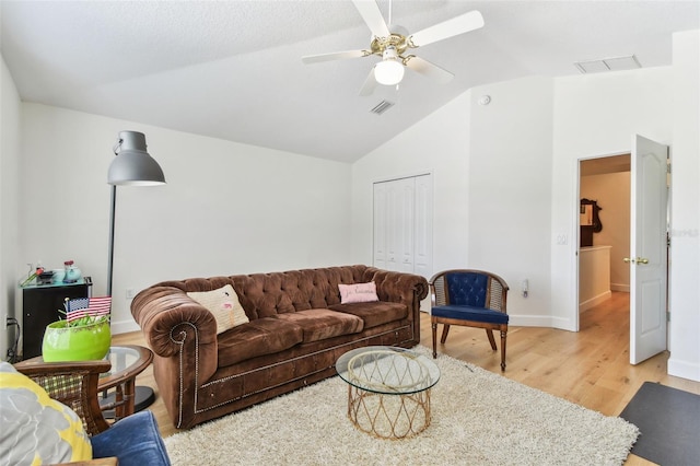 1120 Bluffs Cir, Dunedin, FL 34698 - living room with vaulted ceiling, light wood-style floors, and a ceiling fan