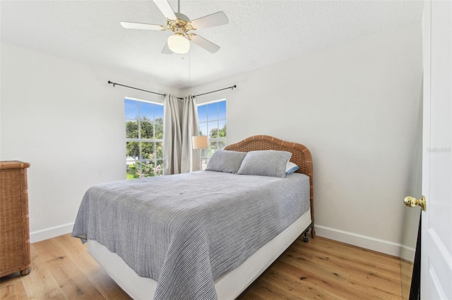 1120 Bluffs Cir, Dunedin, FL 34698 - bedroom with wood finished floors and a ceiling fan