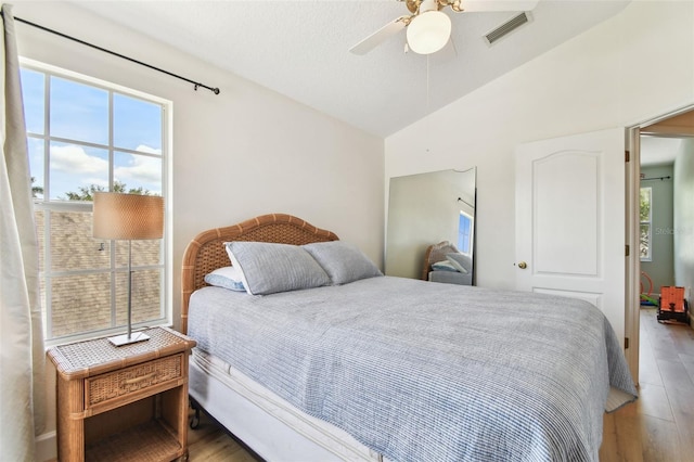 1120 Bluffs Cir, Dunedin, FL 34698 - bedroom with lofted ceiling, wood finished floors, and a ceiling fan