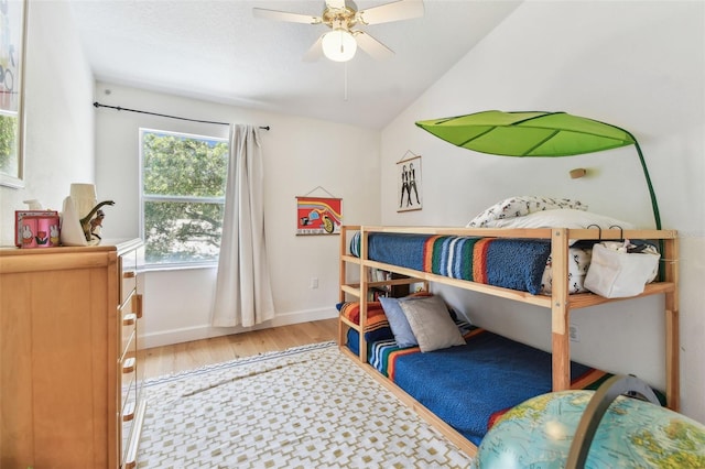 1120 Bluffs Cir, Dunedin, FL 34698 - bedroom with wood finished floors, vaulted ceiling, and a ceiling fan