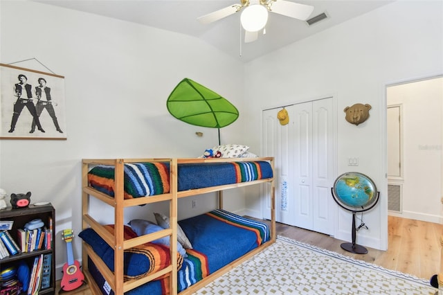 1120 Bluffs Cir, Dunedin, FL 34698 - bedroom featuring wood finished floors, a closet, a ceiling fan, and lofted ceiling
