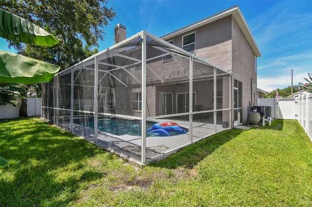 1120 Bluffs Cir, Dunedin, FL 34698 - back of property with a fenced backyard, a patio, a chimney, stucco siding, and ceiling fan