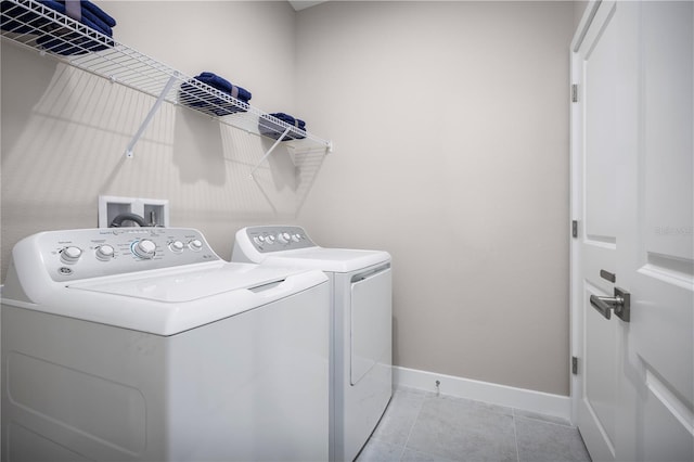 118 Venetian Palms Blvd, New Smyrna Beach, FL 32168 - laundry room with washer and dryer and tile patterned flooring