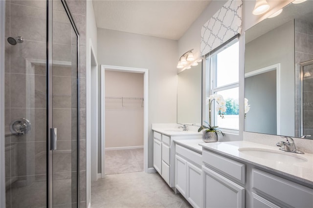 118 Venetian Palms Blvd, New Smyrna Beach, FL 32168 - bathroom with a stall shower, vanity, a walk in closet, and tile patterned flooring
