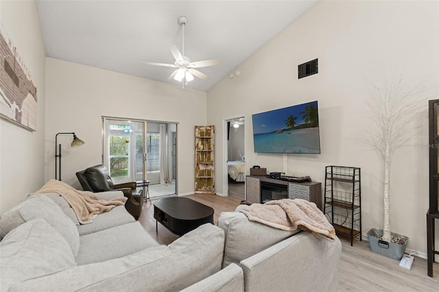 6519 Thicket Trl, New Port Richey, FL 34653 - living area with wood finished floors, a ceiling fan, and high vaulted ceiling