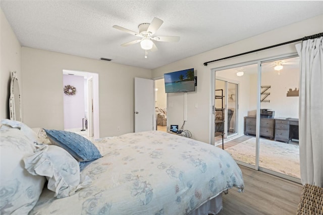 6519 Thicket Trl, New Port Richey, FL 34653 - bedroom featuring wood finished floors, a ceiling fan, and a textured ceiling