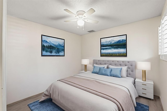 6519 Thicket Trl, New Port Richey, FL 34653 - bedroom with wood finished floors and ceiling fan