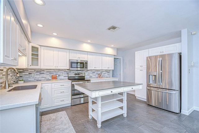 5523 Carlton Rd, New Port Richey, FL 34652 - kitchen with appliances with stainless steel finishes, open shelves, decorative backsplash, white cabinetry, and recessed lighting