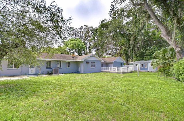 5523 Carlton Rd, New Port Richey, FL 34652 - rear view of house featuring an outbuilding and stucco siding