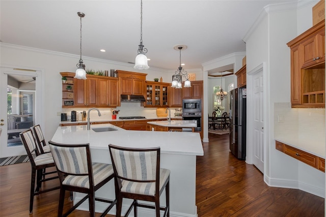 10508 Pontofino Cir, Trinity, FL 34655 - kitchen featuring an island with sink, open shelves, brown cabinets, light countertops, and tasteful backsplash