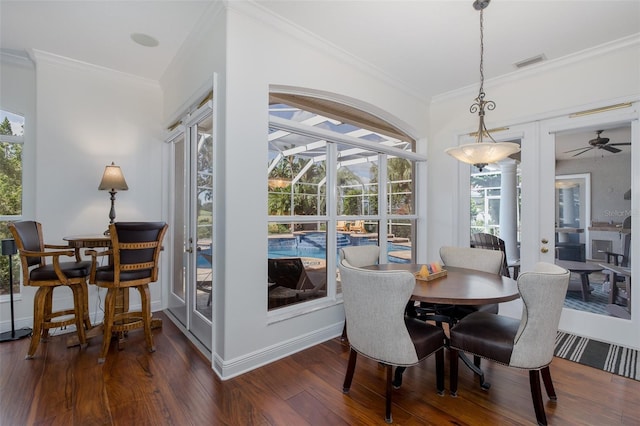 10508 Pontofino Cir, Trinity, FL 34655 - dining area with crown molding, dark wood-style floors, a ceiling fan, and a sunroom