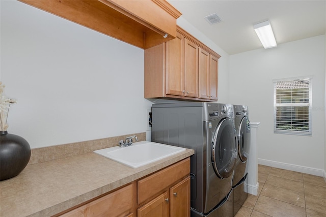 10508 Pontofino Cir, Trinity, FL 34655 - washroom with washer and clothes dryer, cabinet space, and light tile patterned flooring