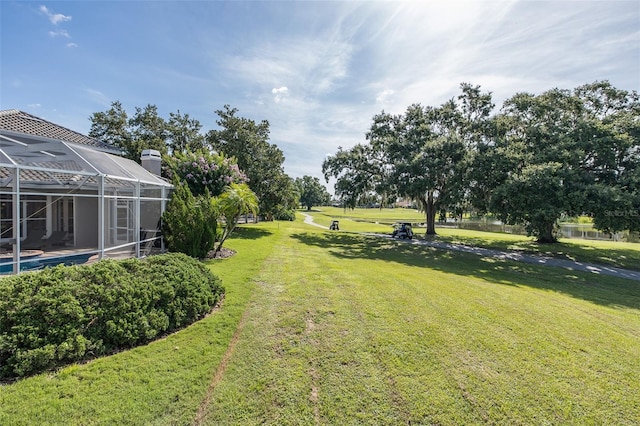 10508 Pontofino Cir, Trinity, FL 34655 - view of green lawn with glass enclosure and an outdoor pool