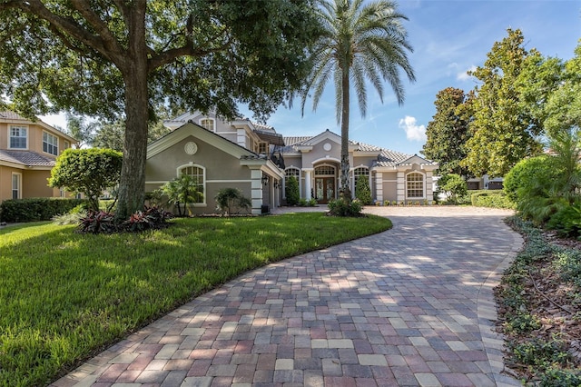 10508 Pontofino Cir, Trinity, FL 34655 - mediterranean / spanish-style home featuring decorative driveway, stucco siding, and a front yard