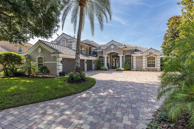 10508 Pontofino Cir, Trinity, FL 34655 - mediterranean / spanish-style house with stucco siding, a balcony, decorative driveway, an attached garage, and a front yard
