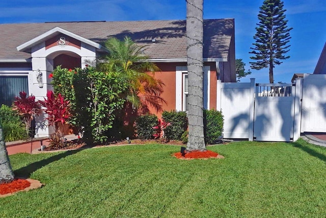 3539 Anniversary Ct, New Port Richey, FL 34653 - view of front of home with stucco siding, a gate, and a shingled roof