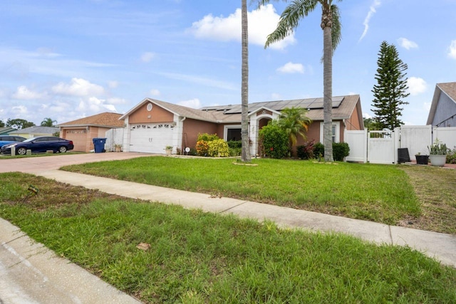3539 Anniversary Ct, New Port Richey, FL 34653 - ranch-style home with solar panels, an attached garage, concrete driveway, a gate, and stucco siding