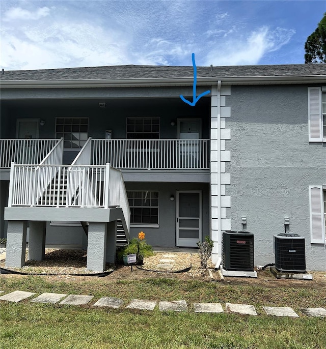 7721 Hillside Ct Unit 203, Hudson, FL 34667 - rear view of house with stairway and stucco siding