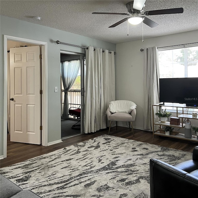 7721 Hillside Ct Unit 203, Hudson, FL 34667 - living area featuring wood finished floors, a ceiling fan, healthy amount of natural light, and a textured ceiling