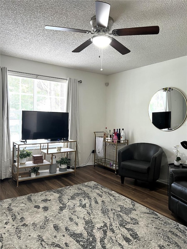 7721 Hillside Ct Unit 203, Hudson, FL 34667 - living area featuring wood finished floors, ceiling fan, and a textured ceiling