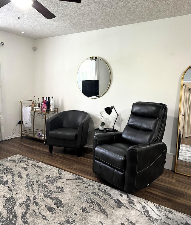 7721 Hillside Ct Unit 203, Hudson, FL 34667 - living area with wood finished floors, ceiling fan, and a textured ceiling