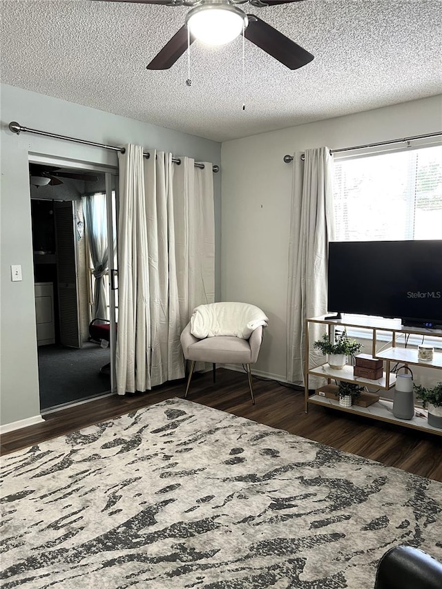 7721 Hillside Ct Unit 203, Hudson, FL 34667 - sitting room with wood finished floors, ceiling fan, and a textured ceiling