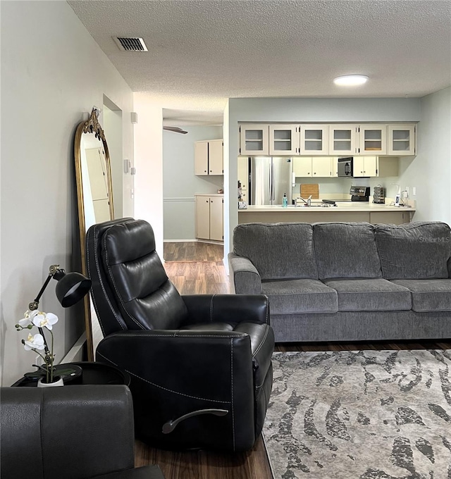 7721 Hillside Ct Unit 203, Hudson, FL 34667 - living area with dark wood-style flooring and a textured ceiling