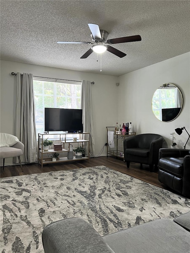 7721 Hillside Ct Unit 203, Hudson, FL 34667 - living room featuring wood finished floors, a ceiling fan, healthy amount of natural light, and a textured ceiling