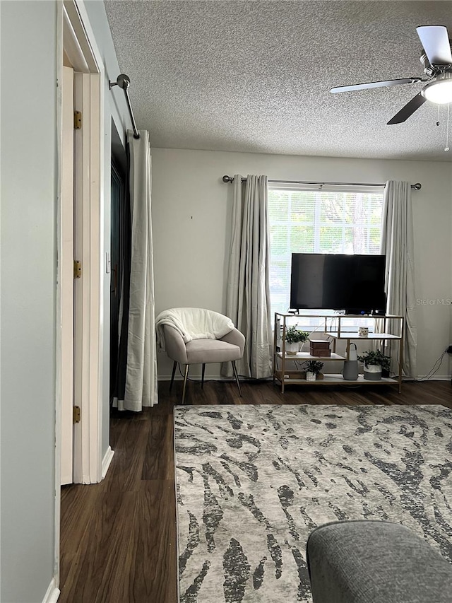 7721 Hillside Ct Unit 203, Hudson, FL 34667 - living room with wood finished floors, a ceiling fan, and a textured ceiling