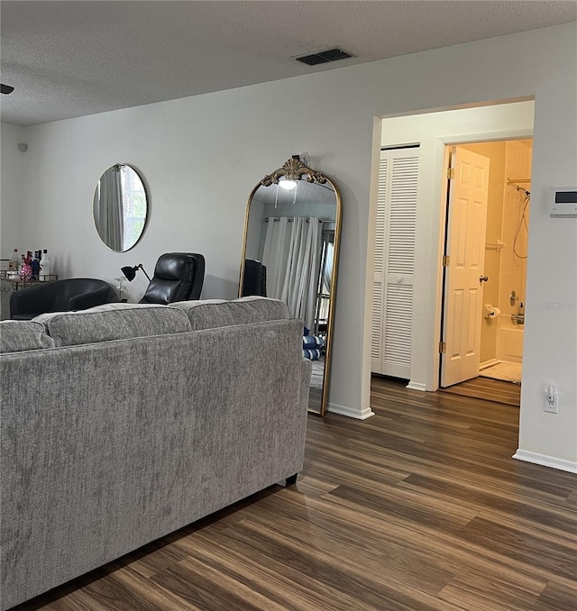 7721 Hillside Ct Unit 203, Hudson, FL 34667 - living room with dark wood finished floors and a textured ceiling