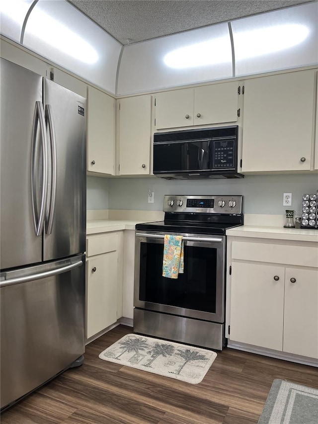 7721 Hillside Ct Unit 203, Hudson, FL 34667 - kitchen featuring stainless steel appliances, light countertops, and dark wood-style flooring