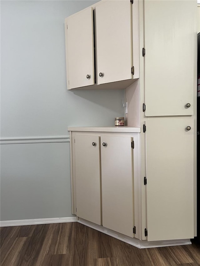 7721 Hillside Ct Unit 203, Hudson, FL 34667 - laundry area with wood finished floors