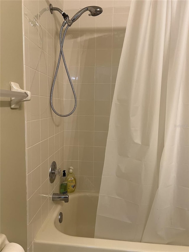 7721 Hillside Ct Unit 203, Hudson, FL 34667 - bathroom featuring shower / bath combo with shower curtain