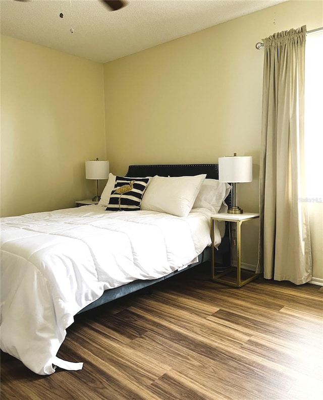7721 Hillside Ct Unit 203, Hudson, FL 34667 - bedroom featuring wood finished floors and a textured ceiling